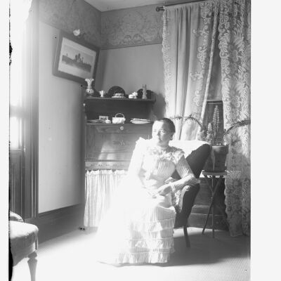 Helen Knickerbocker seated indoors