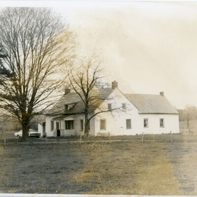 Pitcher Lane farmhouse, with car parked in front.