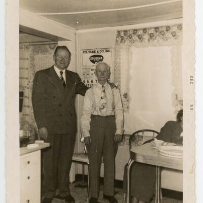 Harold and "Dad" in front of wall calendar
