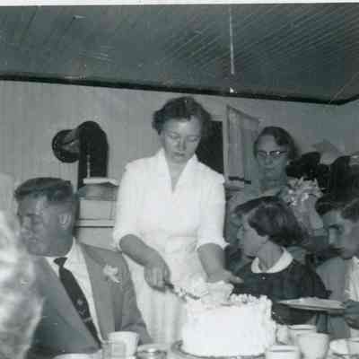 M. Doty cutting wedding cake