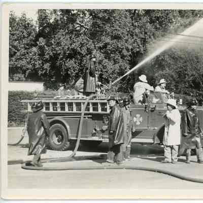 Red Hook Fire Department firemen hosing down building