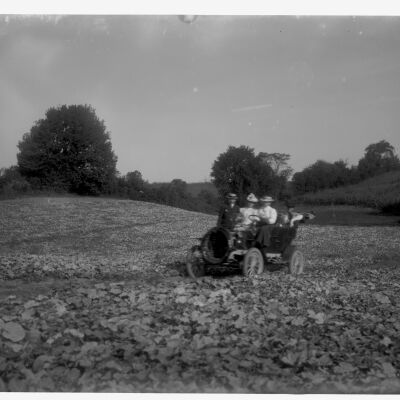 People in car in melon field