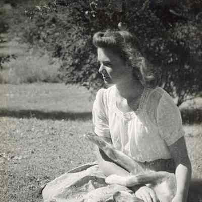 Beth Mead as a young woman, seated outside with dog