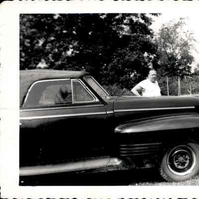 Unidentified man next to a car