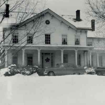 Mead Farmhouse with cars parked in front