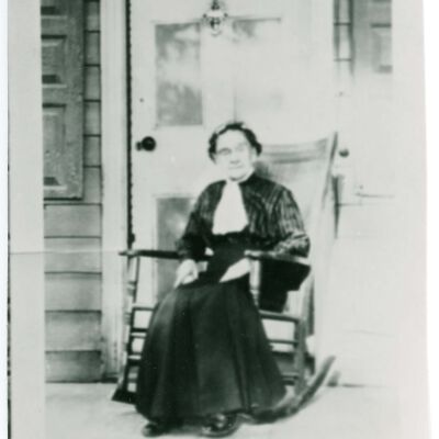 Elizabeth Jewell on front porch of Elmendorph Inn