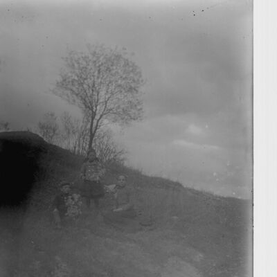 Nena Teator and children sitting on a hillside