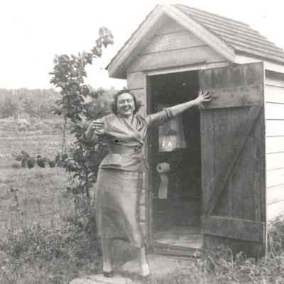 Margaret Riddleburgh Doty in front of out house