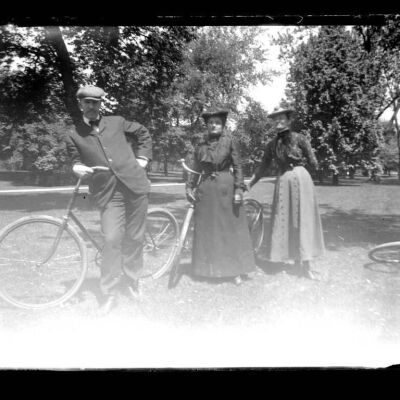 Three people with bicycles (location unknown)
