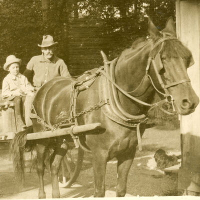 A man and boy sitting in a wagon, Clermont