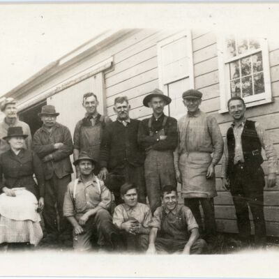 Group posing in front of barn.