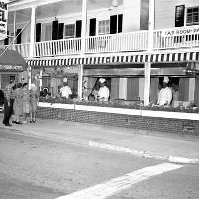 Red Hook Hotel with chefs in front windows, 1960