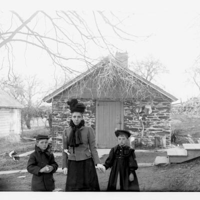 Nena, Roscoe and Marion Teator standing in front of their stone summer kitchen