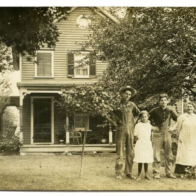 Family standing outside of house