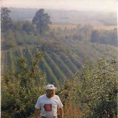 Charles "Chuck" Mead walking in orchards