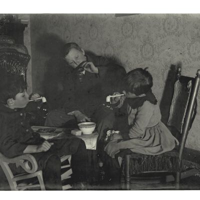 Three children blowing soap bubbles