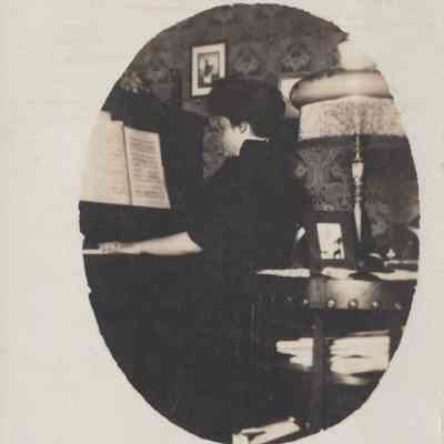 Postcard with photo of Alice at the Piano