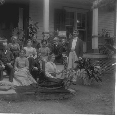 Vosburgh family posing in front of house - two