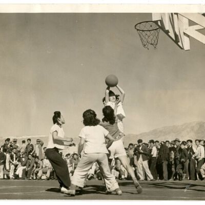 WRA no. B-204: photograph of four girls playing basketball with crowd watching at Manzanar