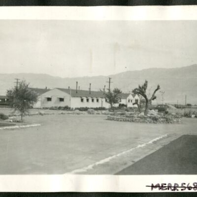 Photograph of administration building at Manzanar with Joshua tree