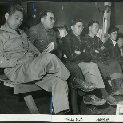 A group of residents of Japanese descent listening to the purpose of the registration which was held at this center. The registration forms were explained to the evacuees by WRA and Army officials.