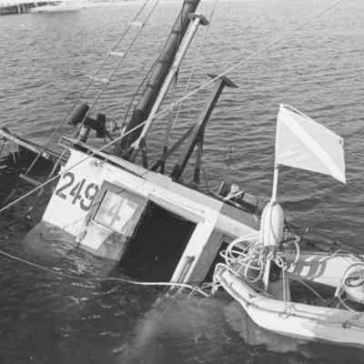 [Photograph of divers examining submerged vessel, c. 1960]