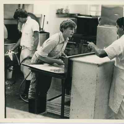 Robert Gosman (center), Mike Ushko(left), and Ali (right). by Maria-Louise Sidoroff PhD | An Inside View of Gosman's Kitchen, Labor Day c. 1975, Montauk Library Archives