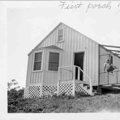 First Sleeping porch goes on Peggy Cahill sits on the framing H.H. Bryan Rd 1942 | Cahill, Stayton, and Eurell Families Collection, Montauk Library Archives