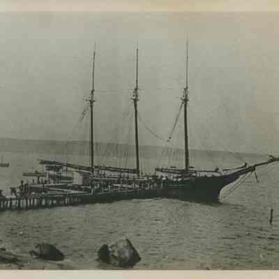 Photograph of a schooner unloading ice on Fort Pond Bay to E. B. Tuthill's ice house, undated.