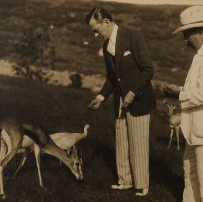 Mayor Jimmy Walker feeding a gazelle and peacock on the estate grounds, 1929 | Andrew J. Thomas - Jackson Estate Album, Montauk Library Archives.