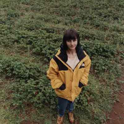 A photo view of a woman standing in a strawberry patch. 7/18/1989.