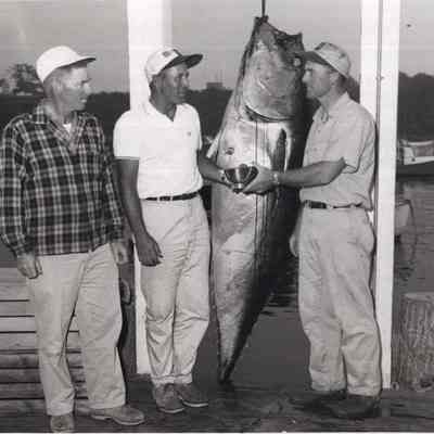 A photo view of 3 fishermen.
