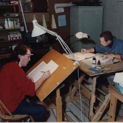 A photo view of two men working. 11/17/1989.