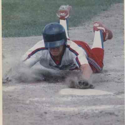 A photo view of Dave Begus sliding into home plate.