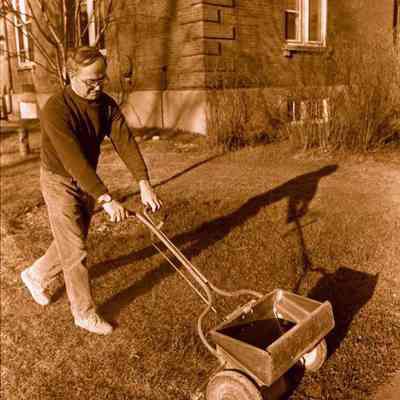 A photo view of Armand Bernier spreading lime. 11/27/1984.