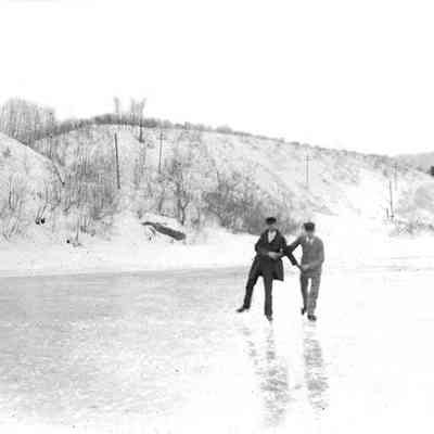 Two Unknown Men Skating