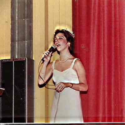 A color photograph of Phyllis Gaudreau Glenn singing the Classic "America"