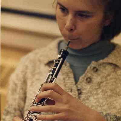 A photo view of a girl playing a musical instrument. 10/17/1988.