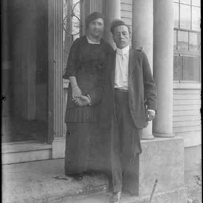 A couple standing in front of a door.