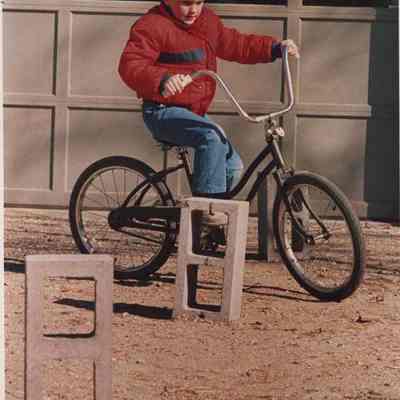 A photo view of a boy on a bicycle. 4/19/1987.