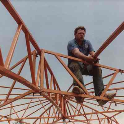 A photo view of a workman assembling a structure. 8/4/1989.