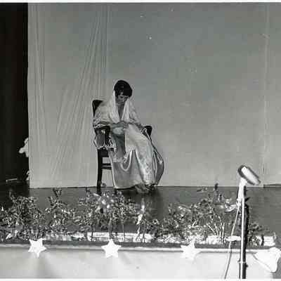 A B/W photograph of a girl sewing.