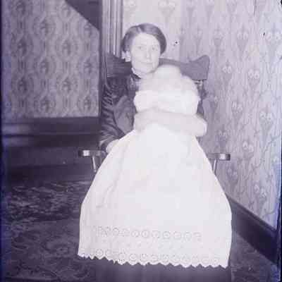A negative of a woman holding a baby.