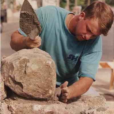 A photo view of a stone mason. 6/16/1989.