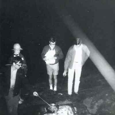A B/W photograph of 4 young men.