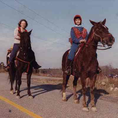 A photo view of 2 women riding horses. 11/19/1990.