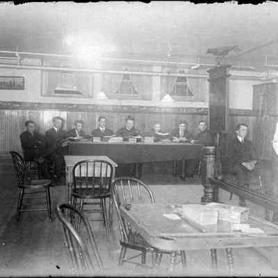 A group of men sitting at a table.