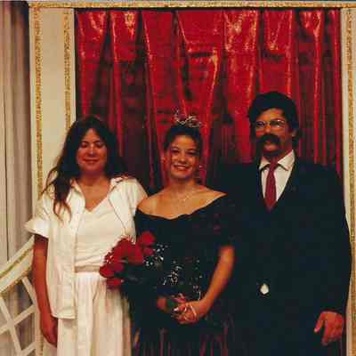 A color photograph of the winning queen and her parents.