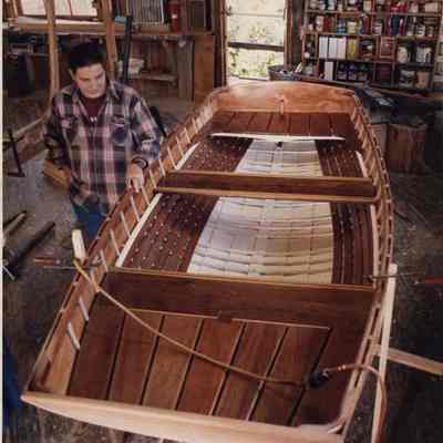 A photo view of a man working on building a boat. 9/25/1991.