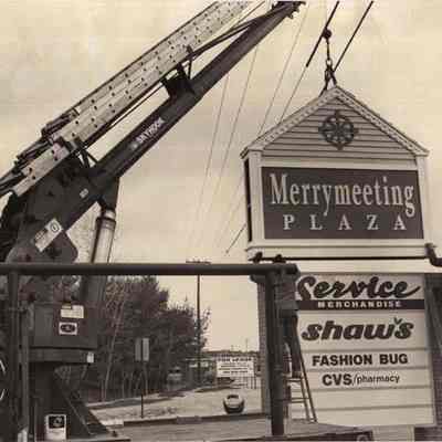 A photo view of a new sign being put in place at Cook's Corner.
